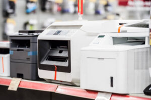 Several laser printers at shelf in electronic computer store